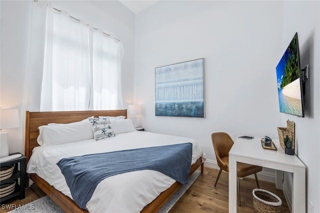 bedroom with hardwood / wood-style flooring