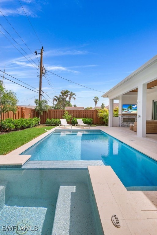 view of swimming pool featuring a diving board and a patio area