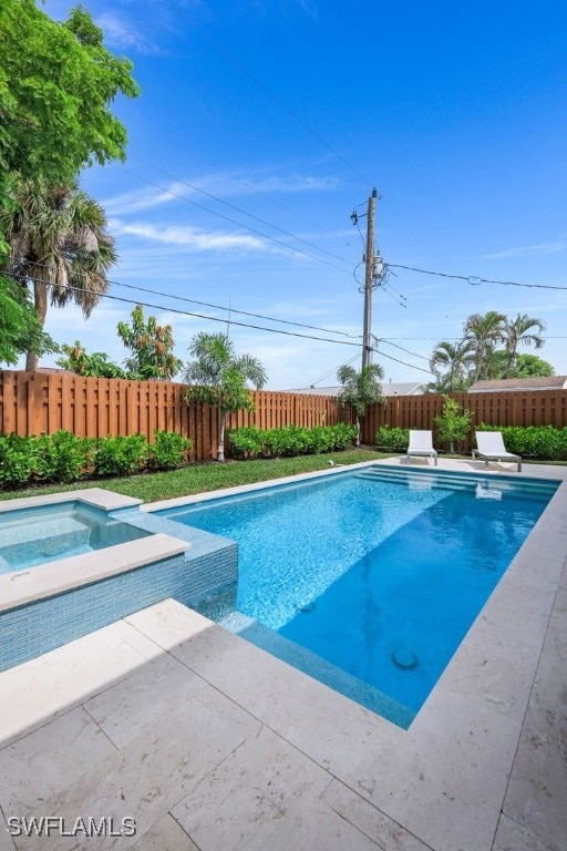 view of pool with an in ground hot tub, a diving board, and a patio area