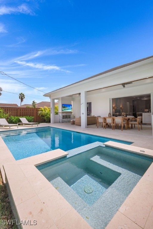 view of pool featuring an in ground hot tub and a patio