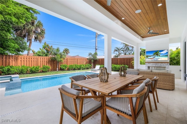 view of swimming pool featuring a patio area and ceiling fan