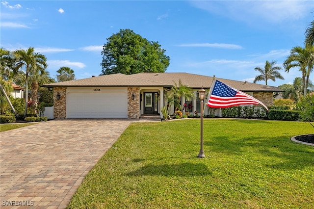 ranch-style house featuring a garage and a front lawn