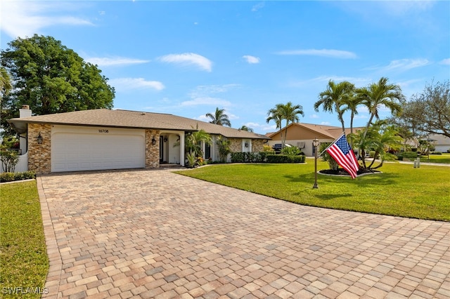 single story home with a garage and a front yard