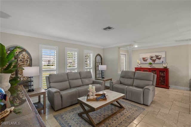 living room with decorative columns and crown molding