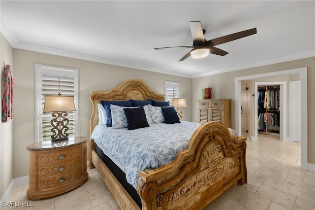 bedroom with ornamental molding, a walk in closet, ceiling fan, and a closet