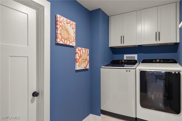 laundry area featuring cabinets and washing machine and dryer