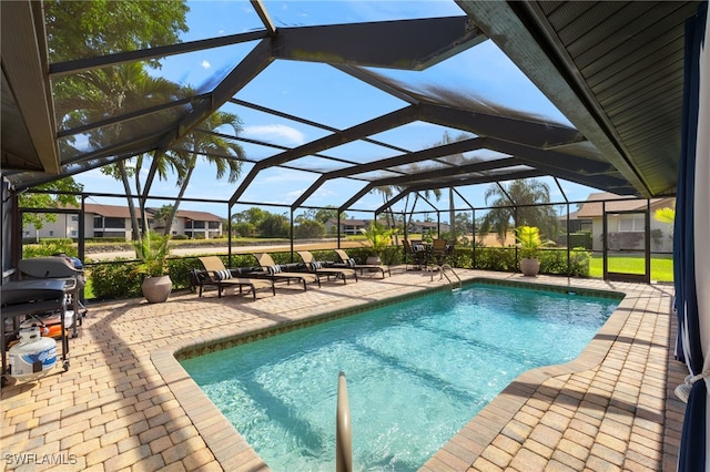 view of swimming pool featuring glass enclosure and a patio area