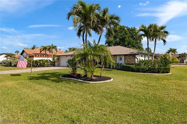 ranch-style house featuring a garage and a front lawn