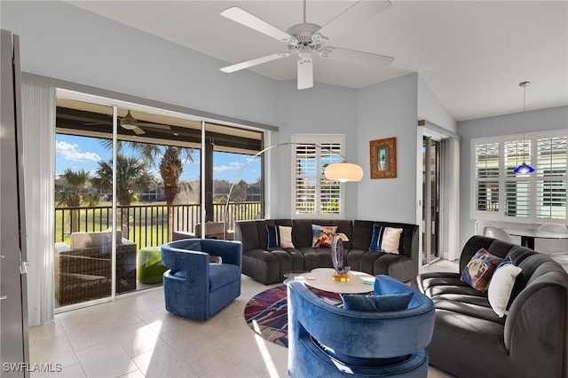 living room featuring a wealth of natural light, ceiling fan, and light tile patterned floors