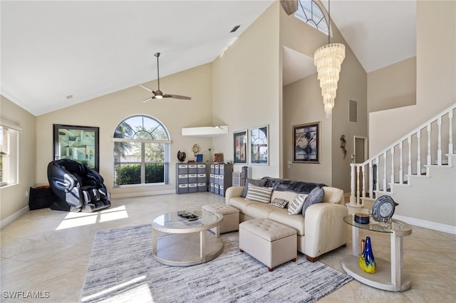 living room with ceiling fan with notable chandelier and high vaulted ceiling