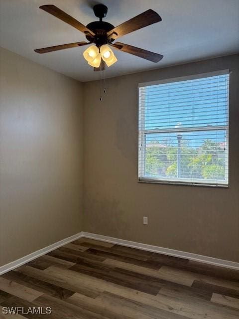 spare room with hardwood / wood-style floors and ceiling fan