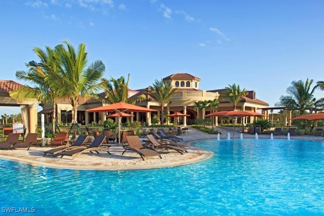 view of pool with pool water feature and a patio