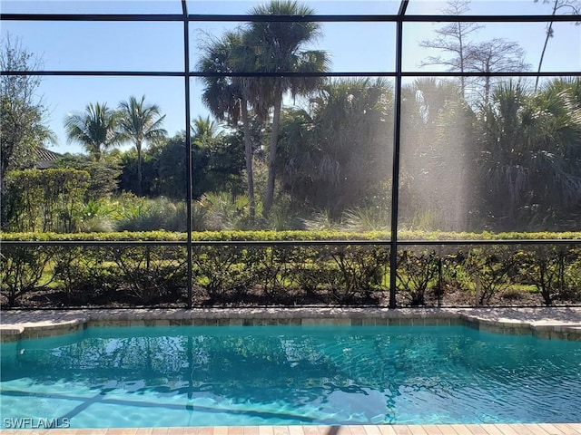 view of pool with glass enclosure