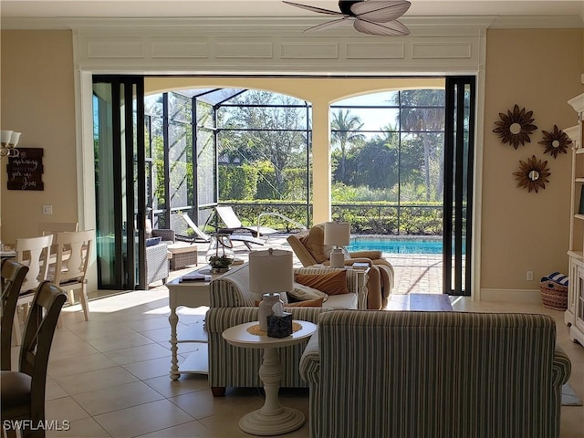 tiled living room with crown molding and ceiling fan