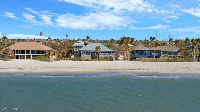 view of front of property with a water view and a view of the beach