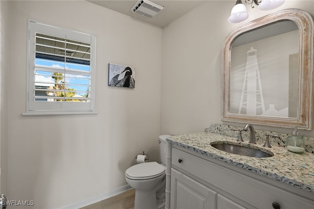 bathroom with vanity and toilet