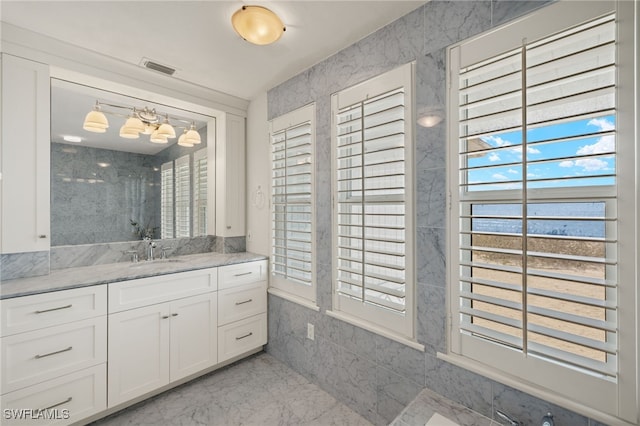 bathroom with vanity and a wealth of natural light