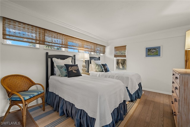 bedroom with wood-type flooring and ornamental molding