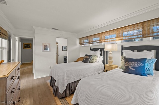 bedroom featuring crown molding and hardwood / wood-style floors