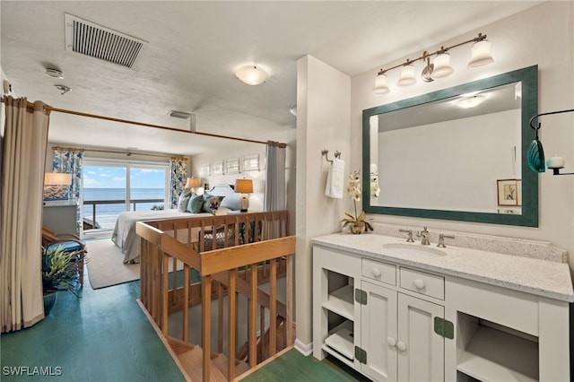 bathroom with vanity, wood-type flooring, and a water view