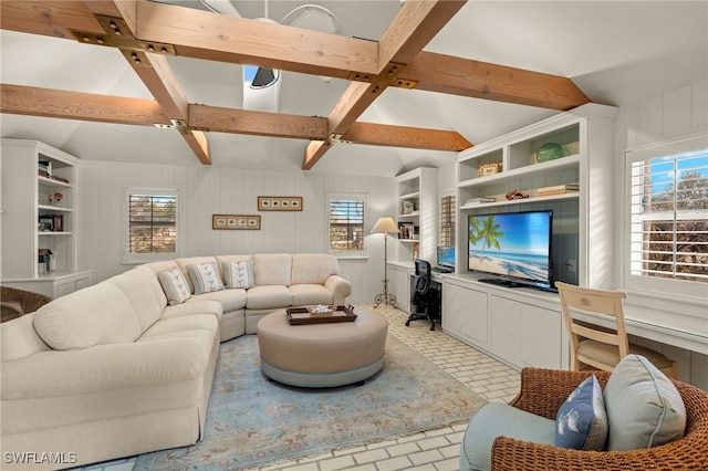 living room featuring lofted ceiling with beams and plenty of natural light