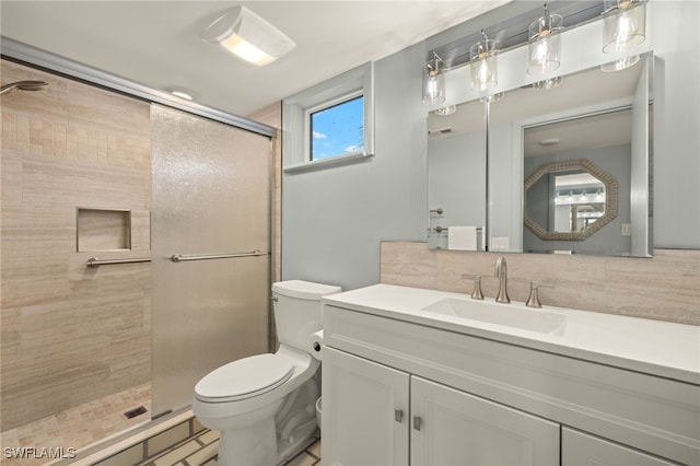 bathroom with vanity, backsplash, toilet, and walk in shower