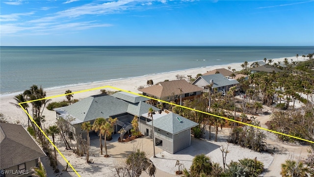 birds eye view of property featuring a view of the beach and a water view