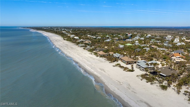 birds eye view of property featuring a view of the beach and a water view