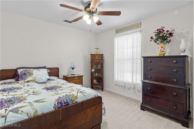 bedroom with multiple windows, light colored carpet, and ceiling fan