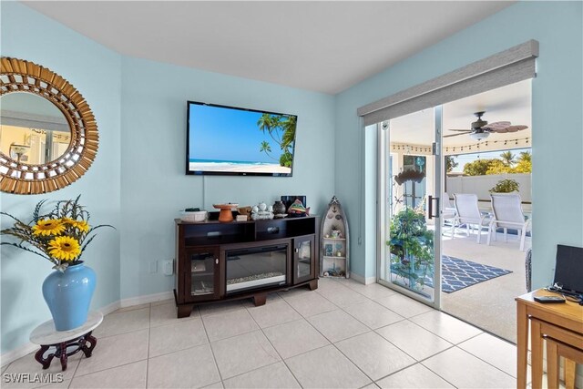 tiled living room featuring ceiling fan