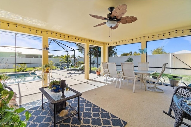 sunroom featuring a wealth of natural light and ceiling fan