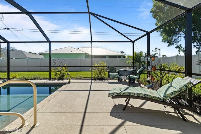 view of pool with a patio and glass enclosure