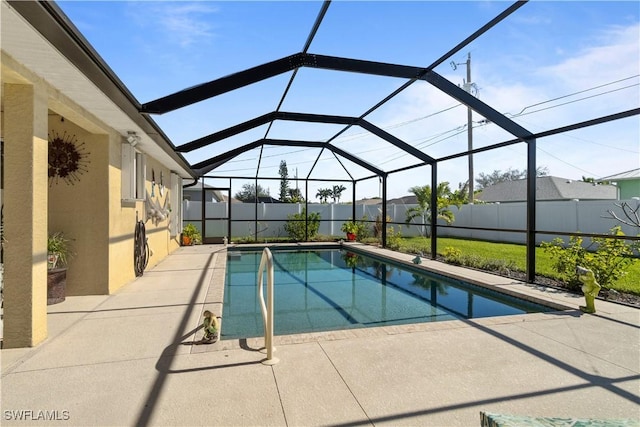 view of pool featuring a patio and glass enclosure