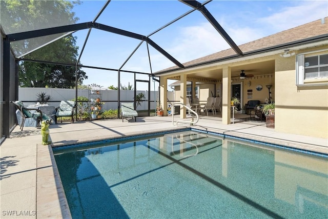 view of pool featuring ceiling fan, a lanai, and a patio