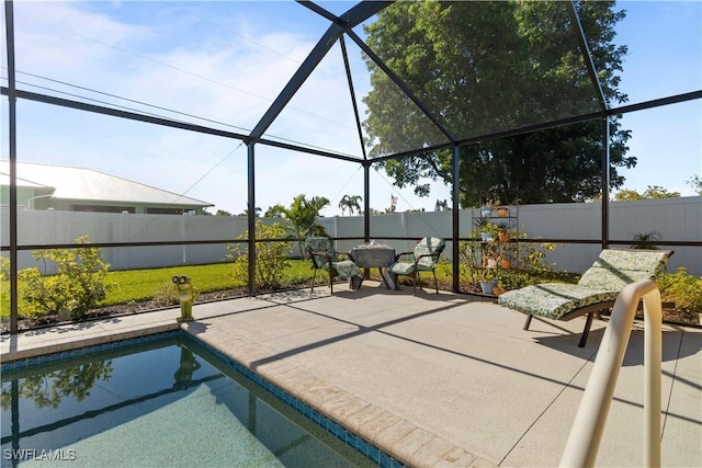 view of patio / terrace with a fenced in pool and glass enclosure