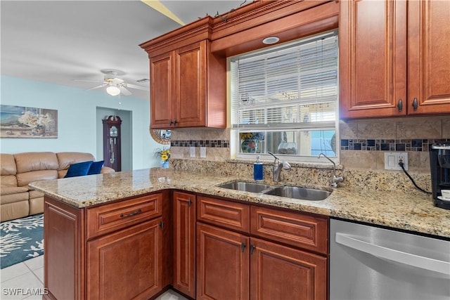 kitchen featuring sink, decorative backsplash, stainless steel dishwasher, light tile patterned floors, and kitchen peninsula