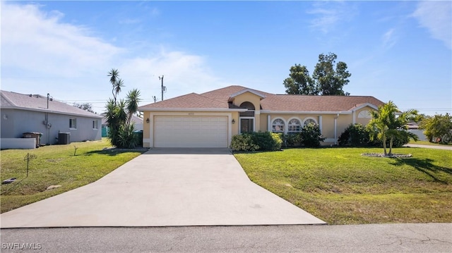 ranch-style home featuring a garage, a front lawn, and central air condition unit