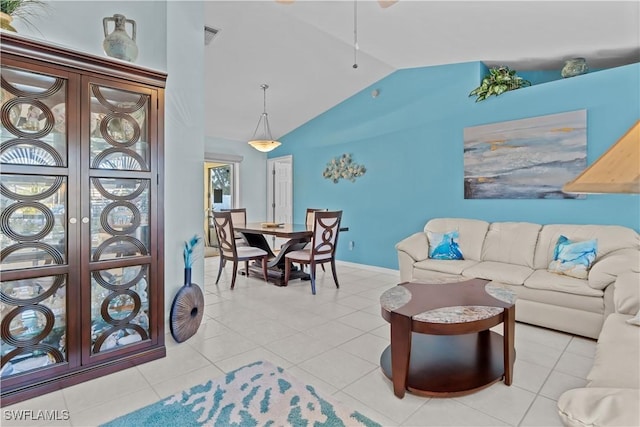 tiled living room featuring vaulted ceiling