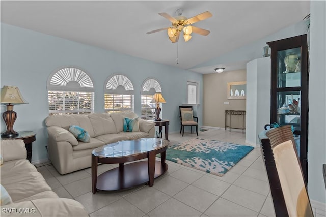 tiled living room with lofted ceiling and ceiling fan