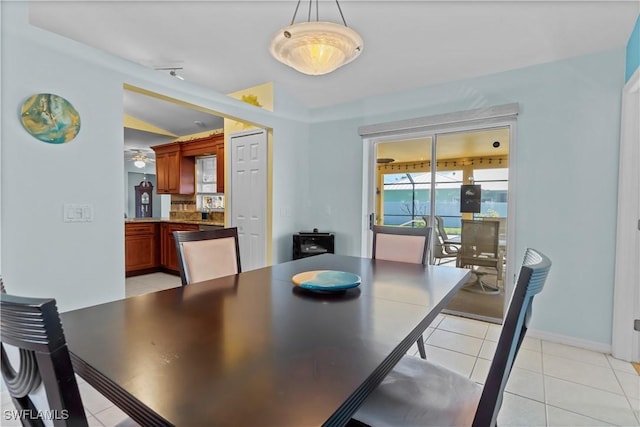 tiled dining room with lofted ceiling