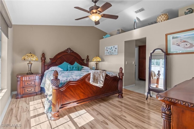 bedroom featuring multiple windows, vaulted ceiling, ceiling fan, and light hardwood / wood-style floors