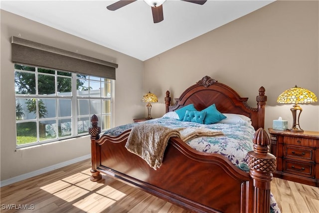 bedroom with lofted ceiling, light hardwood / wood-style floors, and ceiling fan