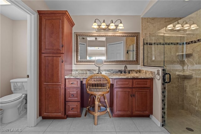 bathroom with vanity, toilet, an enclosed shower, and tile patterned flooring