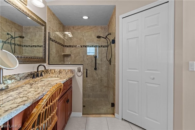 bathroom featuring vanity, a shower with shower door, and tile patterned floors