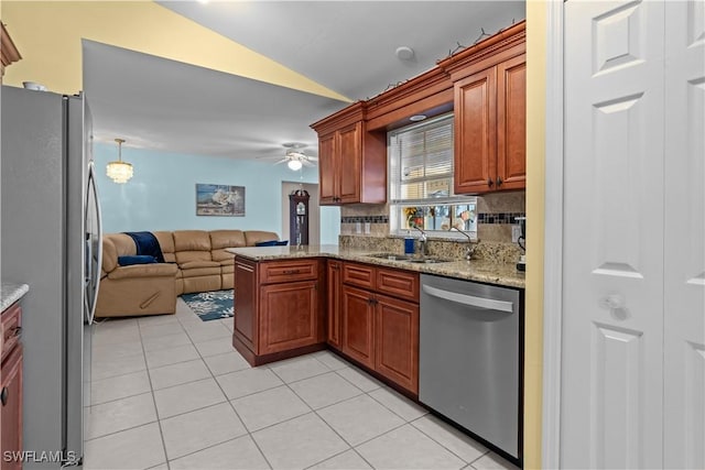 kitchen with backsplash, stainless steel appliances, light tile patterned flooring, vaulted ceiling, and kitchen peninsula