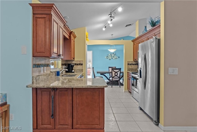 kitchen with stainless steel appliances, vaulted ceiling, sink, and backsplash