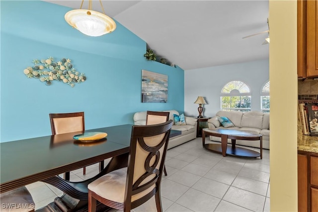 tiled dining room with lofted ceiling