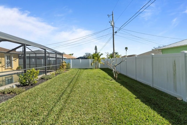 view of yard with glass enclosure