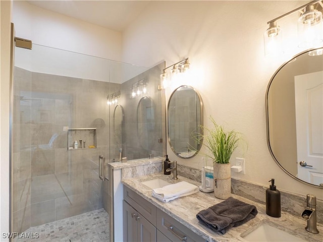 bathroom featuring vanity and a shower with door