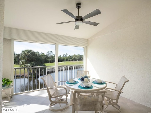 sunroom featuring a water view, ceiling fan, and lofted ceiling